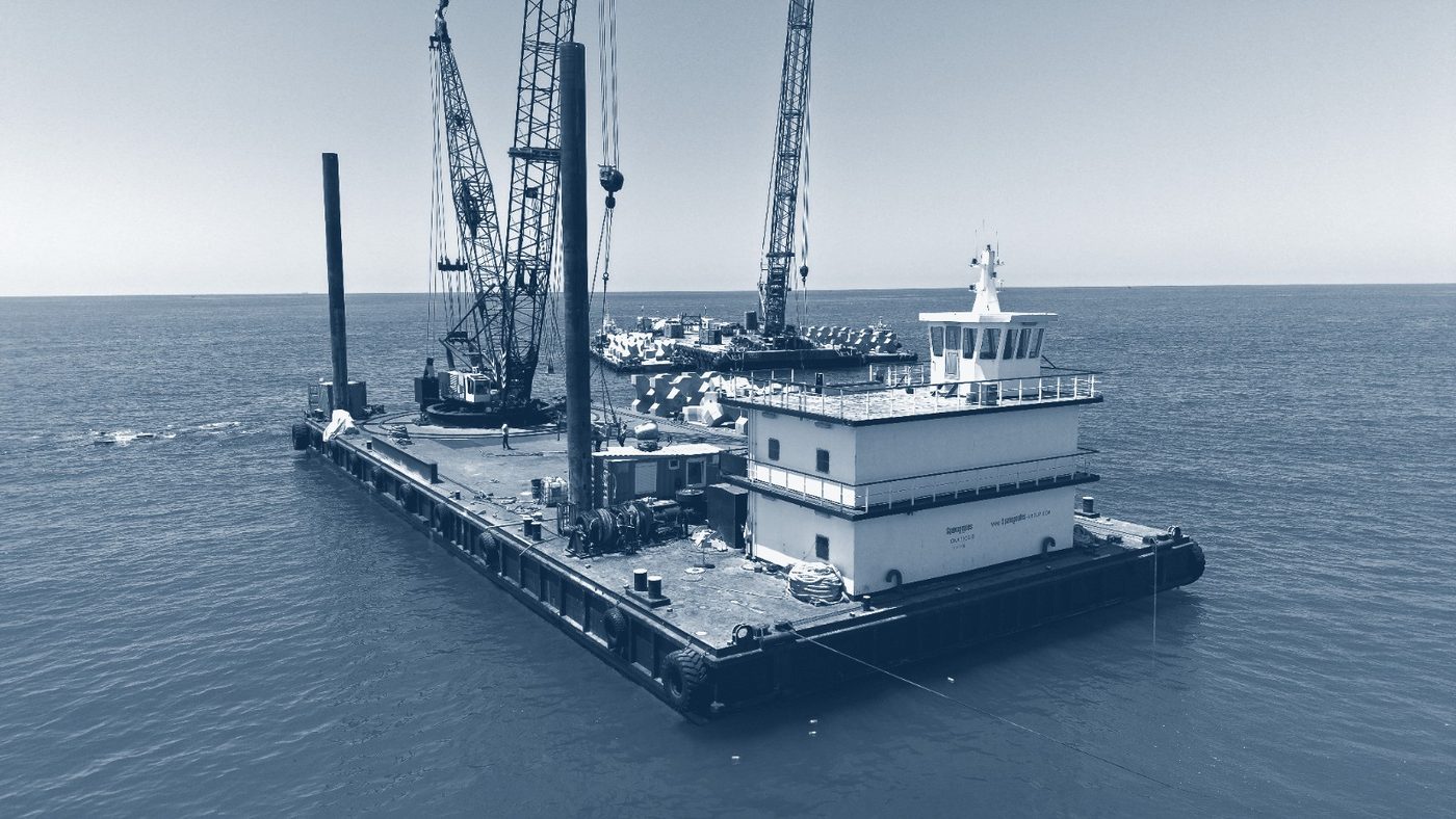 Crane barge at sea with armour units on deck