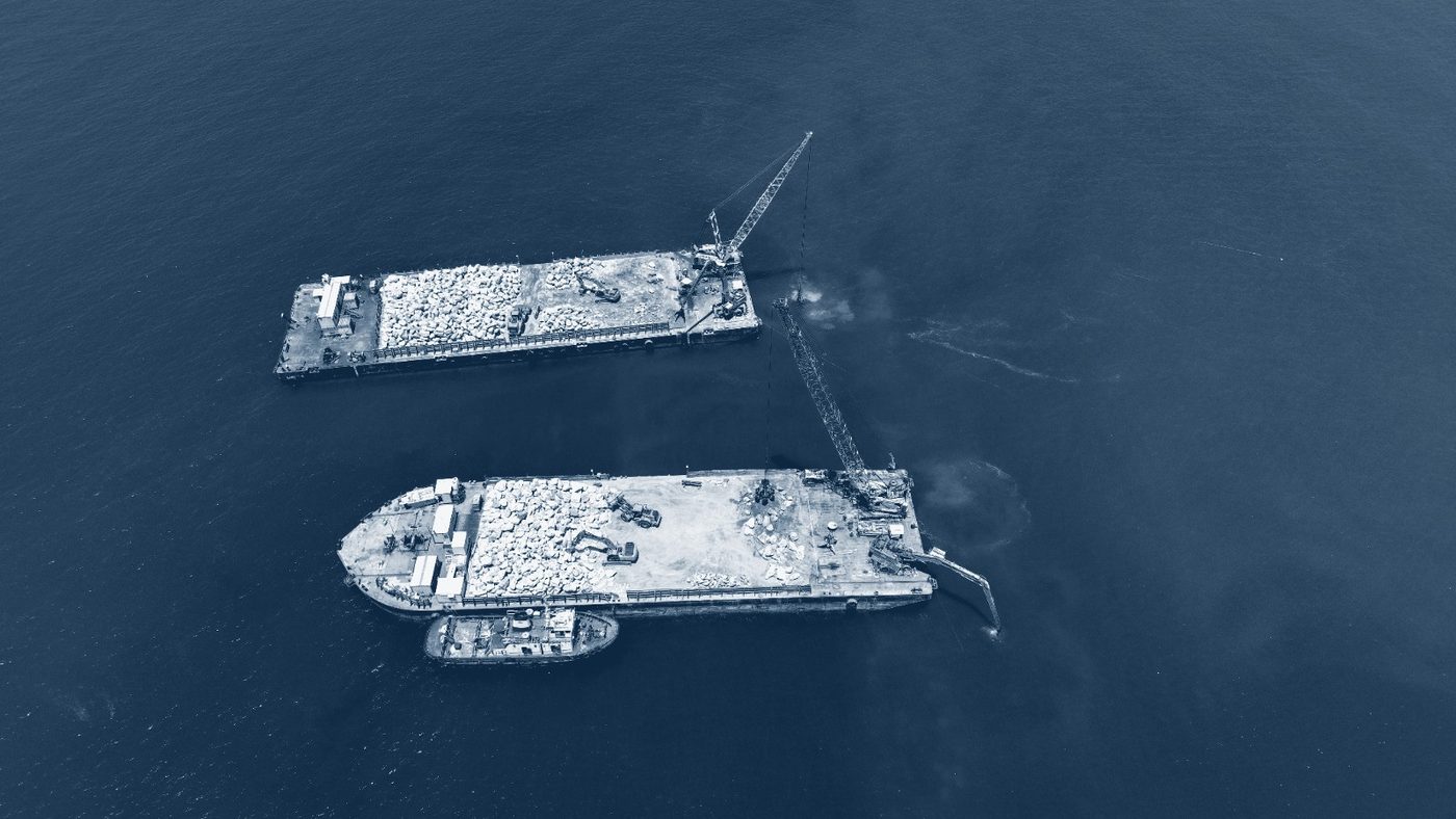 Piling barge with cranes on calm water